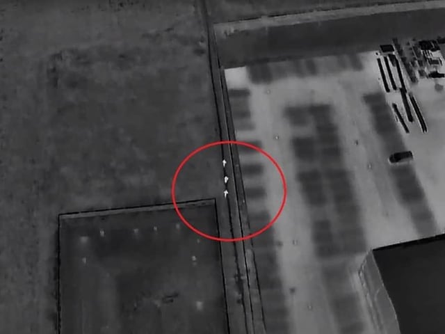 A screenshot of the drone footage showing the offenders (circled) attempting to escape. Photo: YouTube