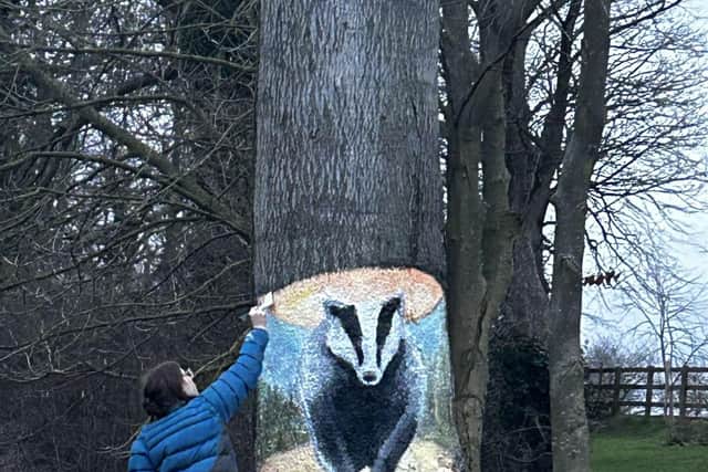 Nikita Spires creating the badger mural on Eastfield Road.