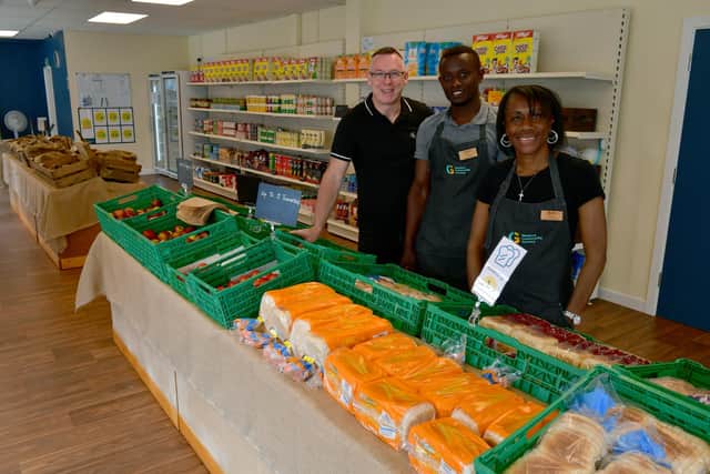 Community Grocery Store is proving a lifeline, from left - Rod Munro, Dennis Obundu - manager, Wendy Roper - assistant manager.