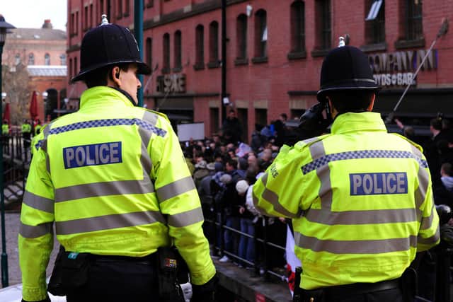 Police watch the English Defence League protesters on the waterfront in Nottingham.