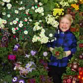 Dobbies Little Seedlings Ambassador, Fergus Bisset, 6, celebrates the first day of spring as Dobbies Boston unveils its largest ever spring gardening range.