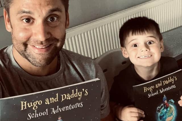 Ric Hart and his son Hugo with copies of Hugo and Daddy's School Adventures.