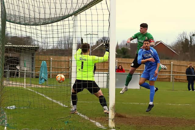 Charlie Ward gets up to head home the equaliser against Belper. Photo: Steve W Davies Photography.