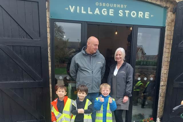Osbournby village shop keepers Ian and Janey with the visiting reception children from Osbournby School.