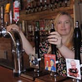 Catherine Mitchell with their range of beers including Putin's Porter and Kim Jong Ale.
