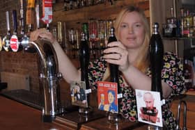 Catherine Mitchell with their range of beers including Putin's Porter and Kim Jong Ale.