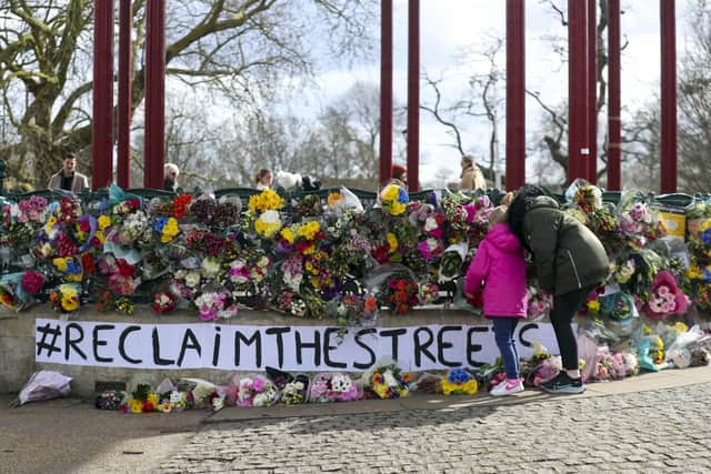 People leave floral tributes at the band stand in Clapham Common, London, after the Reclaim These Streets vigil for Sarah Everard was officially cancelled. Serving police constable Wayne Couzens, 48, was charged on Friday evening with kidnapping and killing the marketing executive, who went missing while walking home from a friend's flat in south London on March 3. Picture date: Saturday March 13, 2021.