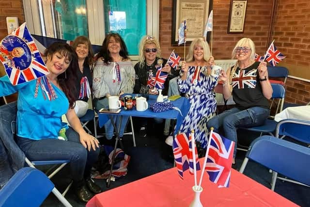 Patriotic ladies enjoying the Coronation celebrations at Meridale Community Centre.