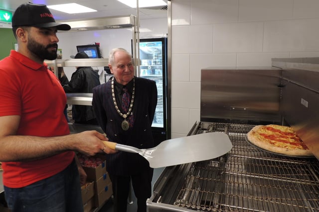 Mayor Anthony Brand awaits the pizzas coming out of the oven ready to be sliced and boxed.