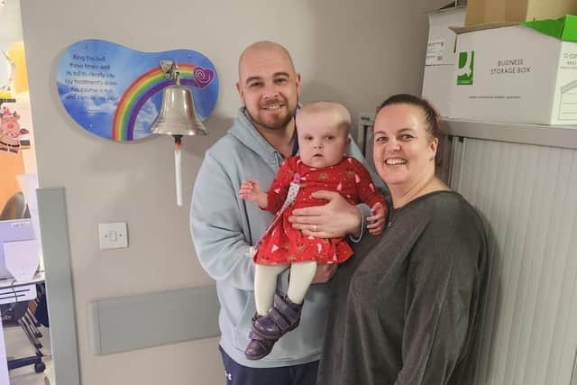 Olivia rings her 'end of treatment' bell with parents Jack and Sally Volley.