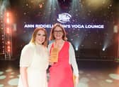 Ann Riddell (right) receives her award from one of the judges.