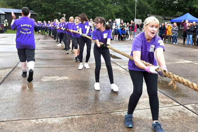 The ladies in action, watched by a crowd. Photos by Mick Fox