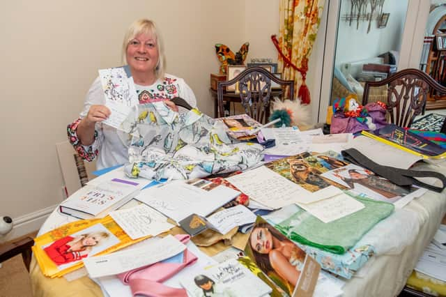 Chris Suich with some of her celebrity auction items.