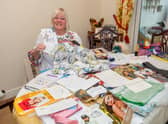 Chris Suich with some of her celebrity auction items.