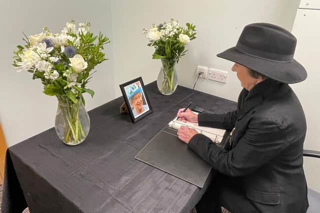 Coun Angela Lawrence signs the book of condolence