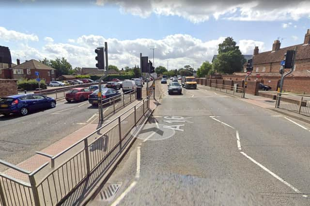 The pedestrian crossing on John Adams Way set to be upgraded. Photo: Google Streetview.