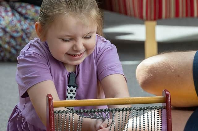 Brookylyn, a patient at St Andrew's Hospice having fun in the sensory room.