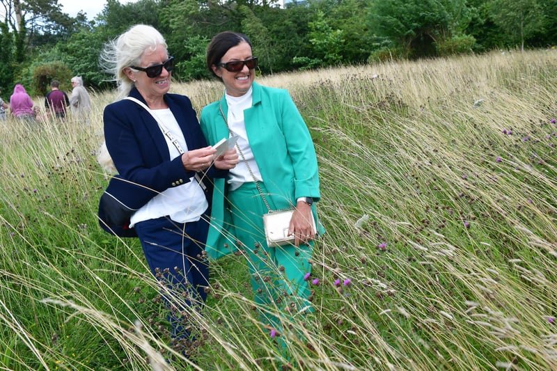 Beverley Harker and Rose Thomas releasing their butterfly in the wildflower field.