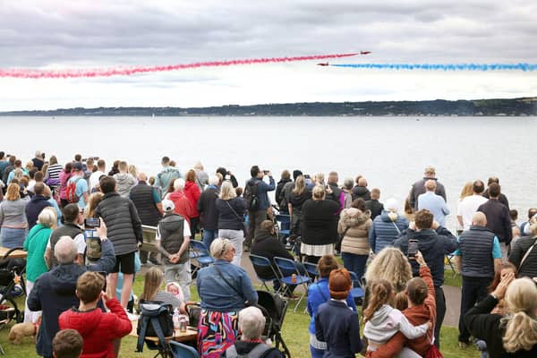 The Red Arrows dazzle spectators with their diamond nine aerobatic display across the shores of Belfast Lough