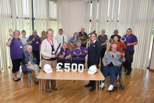 Singing & Sound, a Stroke Association group, pictured with Taylor Wimpey Site Manager Ruth Pollard