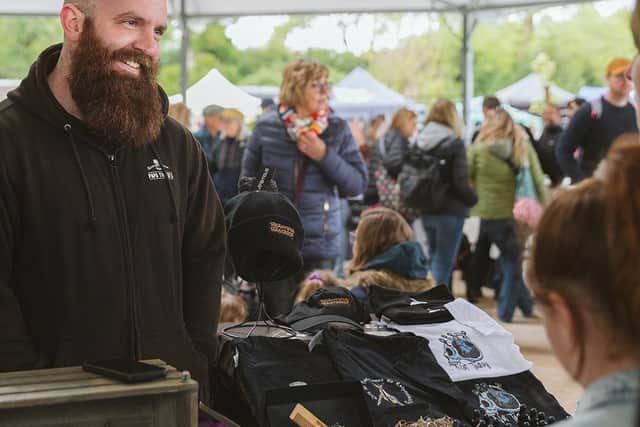 A happy customer at one of the many stalls at last year's spring artisan market at Stourton Woods. (PHOTO BY: Family & Branding Photography by Camila Clarke)