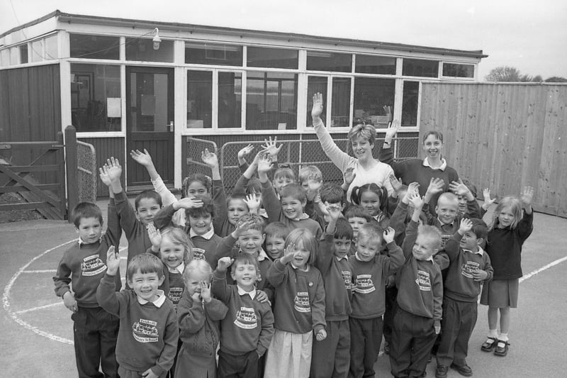 Pupils from Frithville Primary School waving goodbye to their old classroom. The school had been successful in a bid to the Department for Education and Employment to turn a temporary, mobile classroom into a permanent building. The mobile, which was more than 30 years old, was expected to be replaced by April 2001.