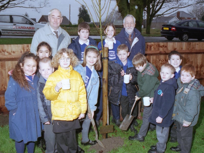 Pupils from Frithville Primary School taking part in a tree-planting scheme, held to mark the millennium. Frithville Parish Council helped to plant the trees, and presented all of the pupils with commemorative mugs. The pupils are pictured with council chairman Derek Park and vice-chairman Dick Paul.