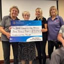 Janice Bedford (second from left) presents a cheque to Three Counties Dog Rescue
