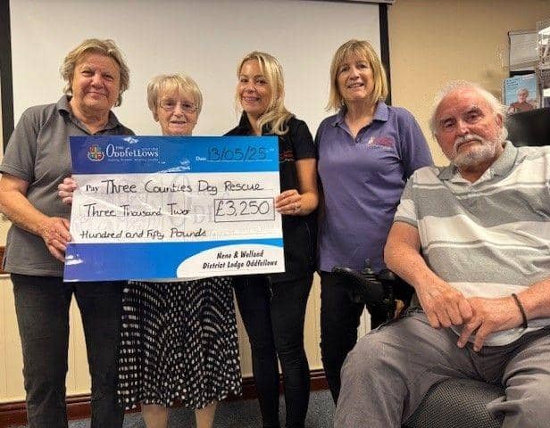 Janice Bedford (second from left) presents a cheque to Three Counties Dog Rescue