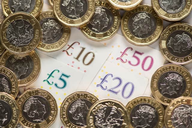 EMBARGOED TO 0001 FRIDAY OCTOBER 14 File photo dated 26/01/18 of a UK five pound, ten pound, twenty pound and fifty pound notes with one pound coins, as city bonuses have increased at more than twice the speed of wages since the 2008 financial crash, research suggests.