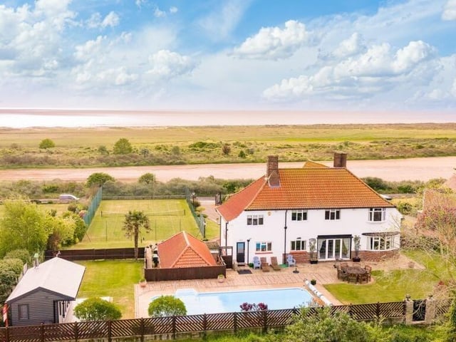 The rear of the home with the seaside in the distance.