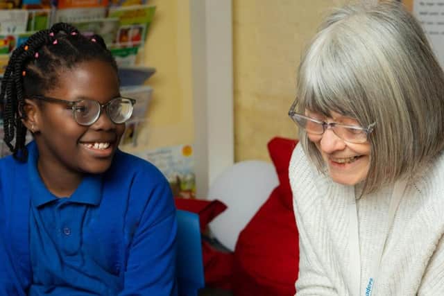 Schoolreaders Volunteer Supporting a Child With Their Reading