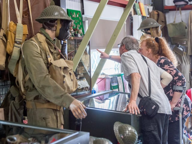 Visitors look at the many war-time exhibits in the museum.