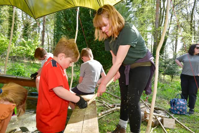 Ewan Fisher, 9, with his mum Joanna Craig making a throwing stick.