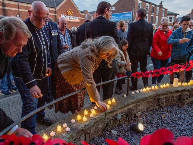 Placing candles during the 80th anniverary of D-Day.
