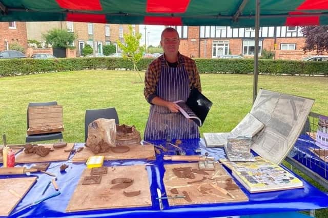 Ceramic artist Shaun Clark helped visitors create small clay tiles, decorated with nature themes