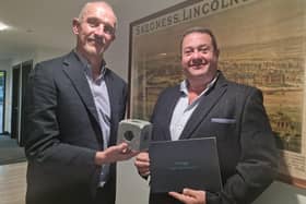 Steve Wright and Richard Arnold of R Arnold Funeral Services with a small  plastic  model of one of the blocks.