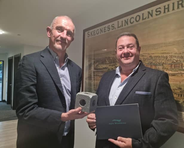 Steve Wright and Richard Arnold of R Arnold Funeral Services with a small  plastic  model of one of the blocks.