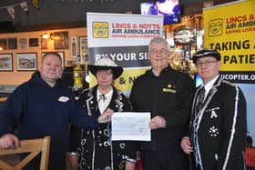 Pearly King amd Queen Pat and Adrian Brown with owner of the Seaview Pub in Skegness Mark Dannatt, presenting a cheque to Steve Tandy of Lincs and Notts Air Ambulance.