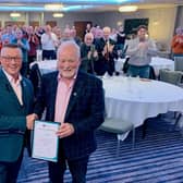 Chris Jones, left, is given his Certificate of Achievement by Howard Wilson, Chair of the MCF Fundraising Committee