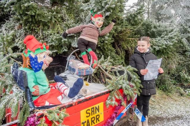Flashback to last year's first elf scavenger hunt in Thimbleby as eight-year-old Hattie Todd finds a couple of likely characters. (PHOTO BY: John Aron Photography)