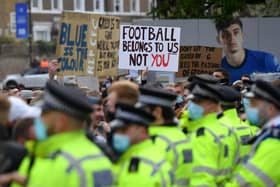 Police line up as Chelsea fans protest against the newly proposed European Super League prior to the Premier League match between Chelsea and Brighton & Hove Albion at Stamford Bridge. (Photo by Mike Hewitt/Getty Images)