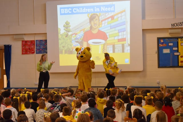 Pudsey Bear greets the crowd at Staniland Academy's morning assembly.