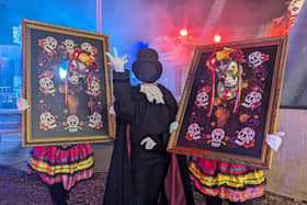 Three of the walkaround performers entertaining crowds inbetween the scare zones.