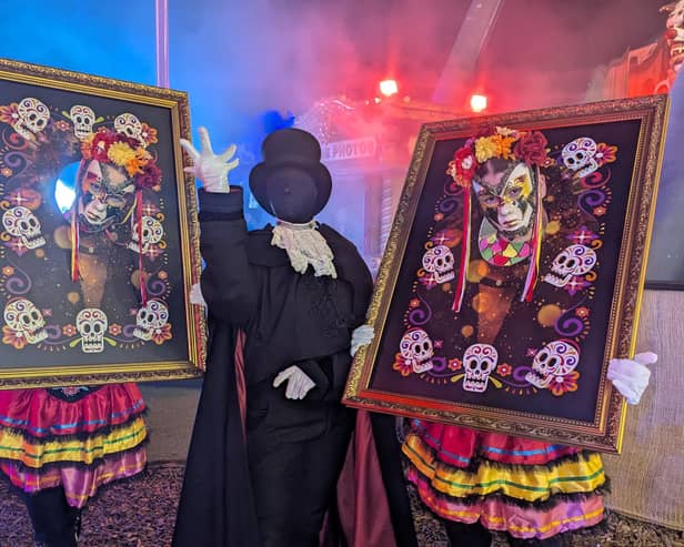 Three of the walkaround performers entertaining crowds inbetween the scare zones.