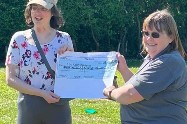 Lisa Thompson (right), the main organiser of the sponsored toddle, presents a cheque to cancer-hit mum Kerry Johnson.
