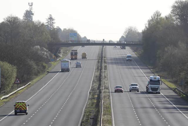 Cars make their way along the M3 motorway near to Fleet in Hampshire, as the UK continues in lockdown to help curb the spread of the coronavirus.
