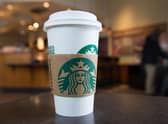 A Starbucks coffee cup (Photo by SAUL LOEB/AFP via Getty Images)