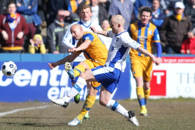 Adam Murray slides the ball down the line in view of the Stags fans.