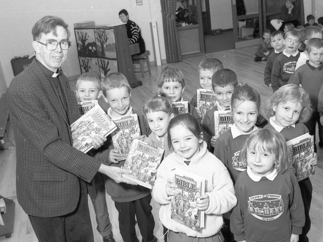 Pupils at Stickney Primary School receiving a special gift courtesy of the Bibles for Children's charity. Depending on their age, the youngsters received either a copy of the Children's Bible Story Book or the Rainbow Good News Children's Bible. Pictured presenting the books is the Rev Christopher Carey, who also gave copies to the school library.